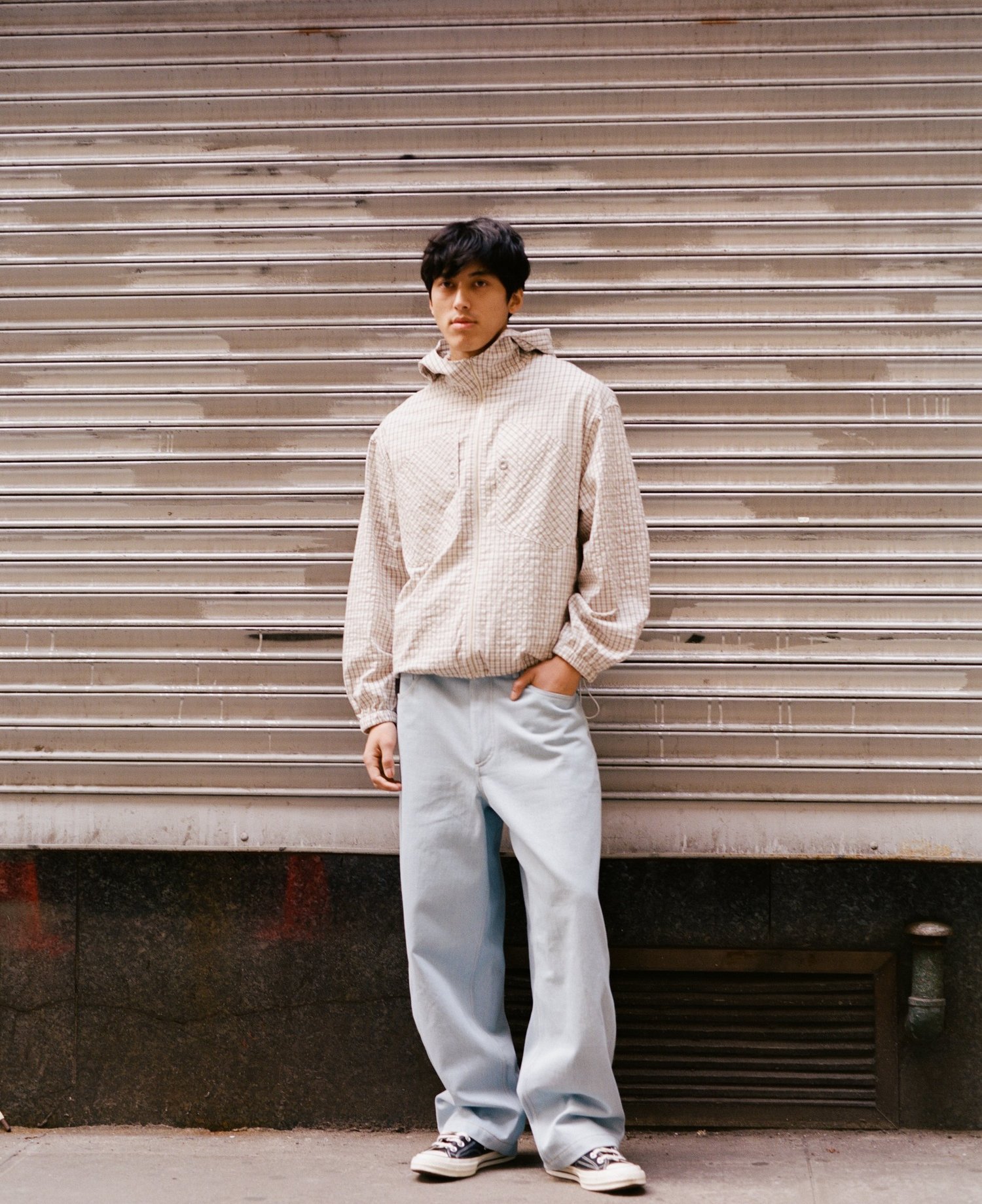 Full-length portrait in front of a metal shutter — ELAREM